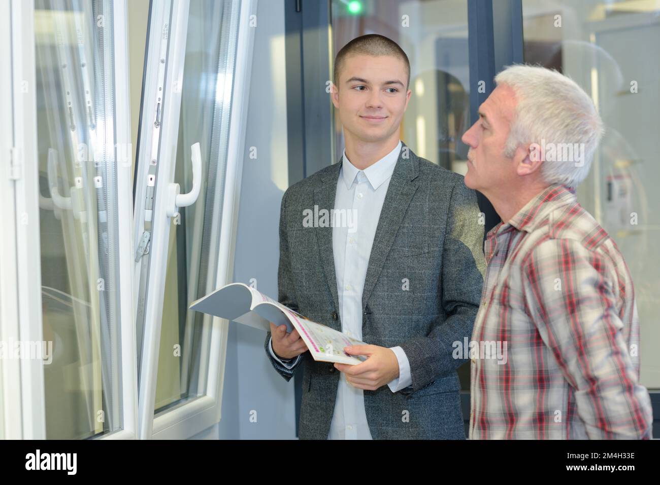 salesman showing double glazed windows to customer Stock Photo