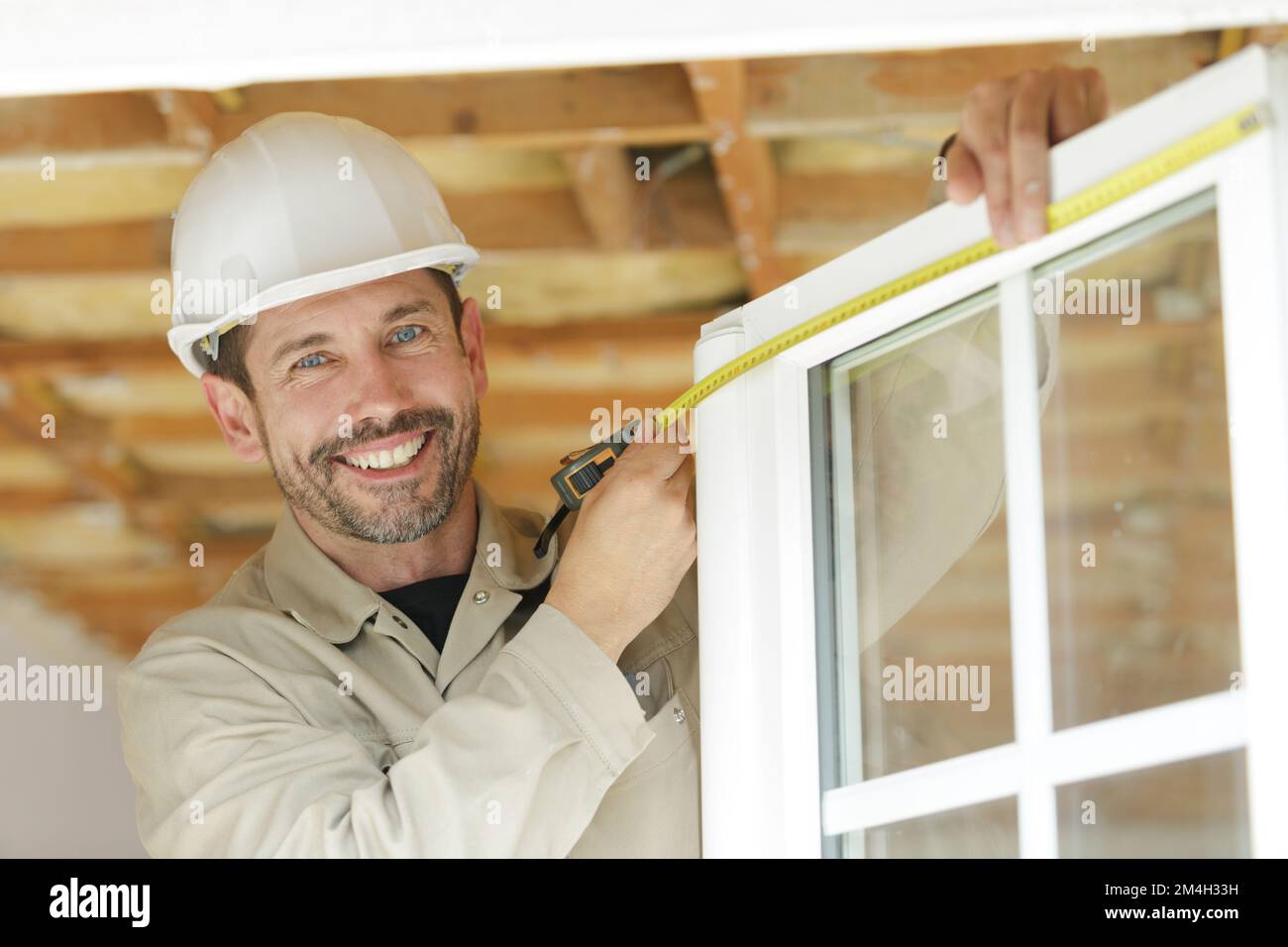 a happy man measuring window Stock Photo - Alamy
