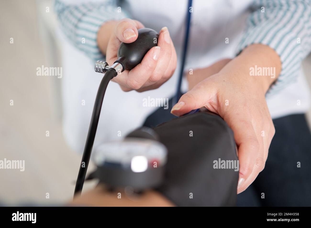 close view of blood pressure cuff being inflated Stock Photo