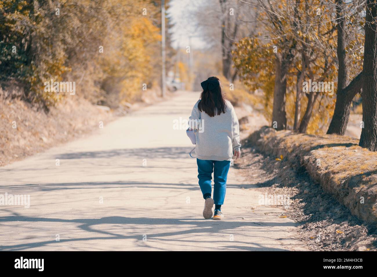 Lonely female person walking hi-res stock photography and images - Alamy