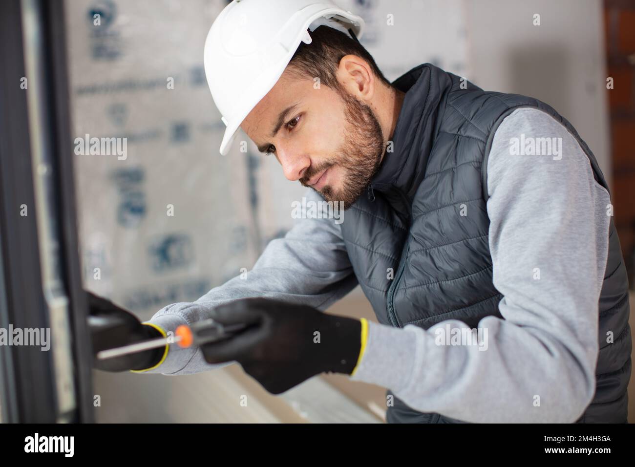electrician installing energy saving meter Stock Photo