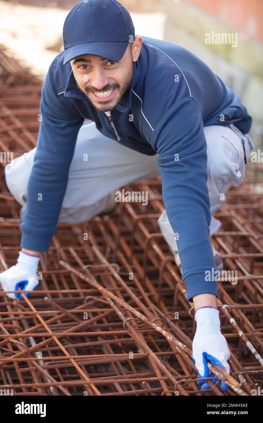 builder in blue uniform working on building foundations Stock Photo