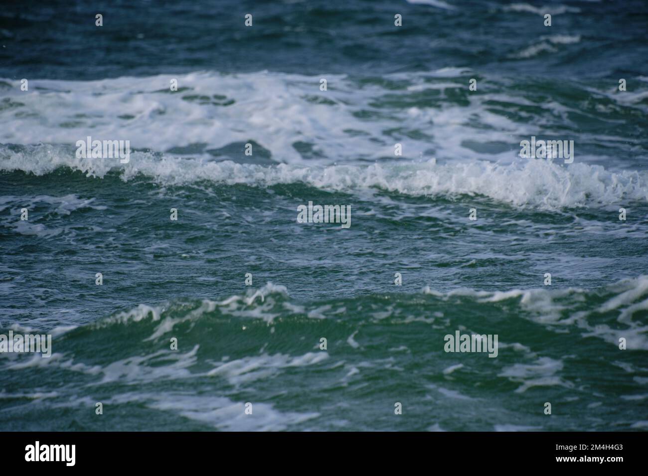 Surf wave with foam splashes on sea Stock Photo
