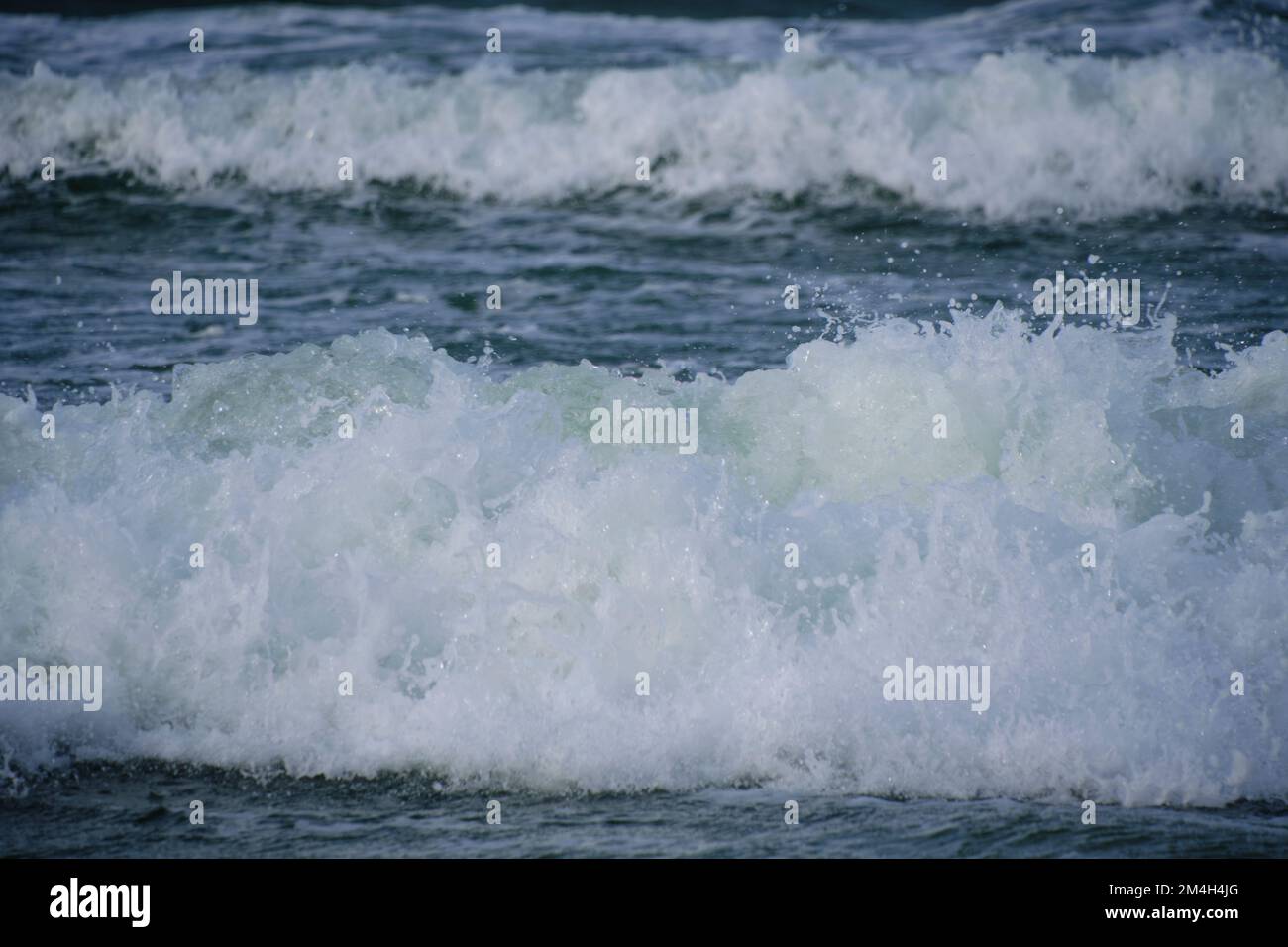 Surf wave with foam splashes on sea Stock Photo