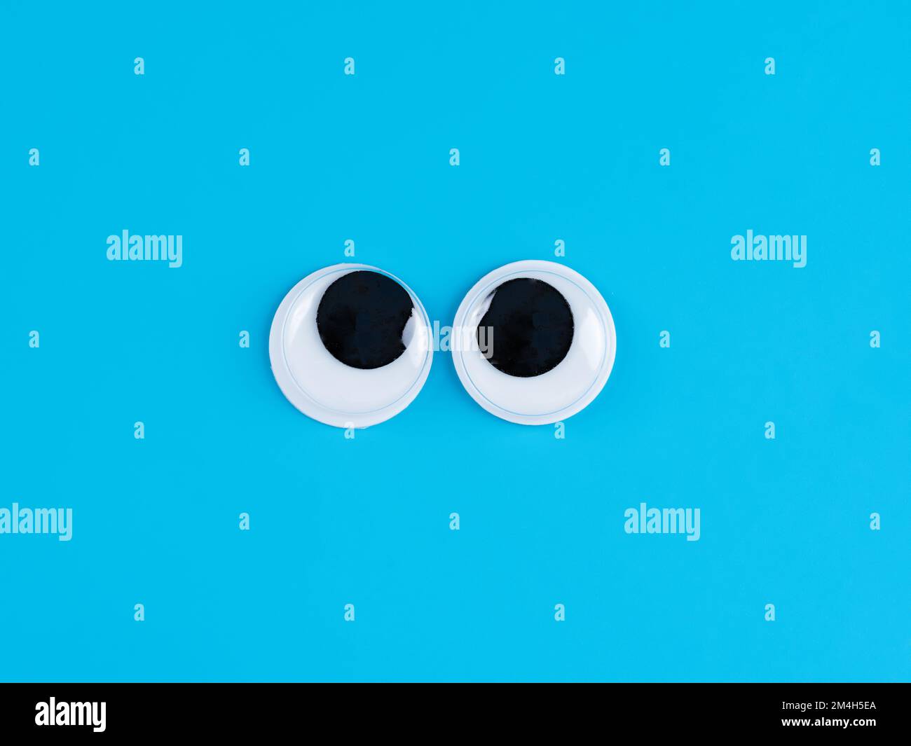 funny googly eyes cute Isolated on bright light blue background copy