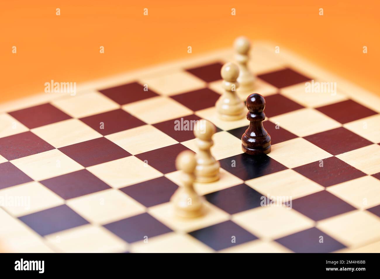 Chess row of white pawns with black pawn challenge center. Chess game strategy Stock Photo