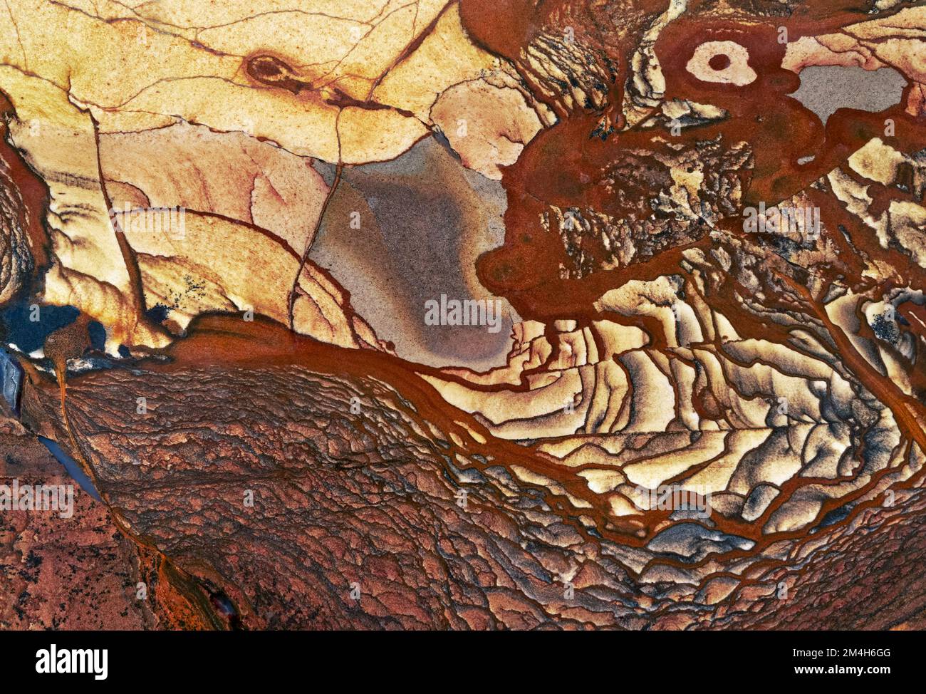 Backgrounds and textures: surface of beautiful brown and yellow decorative stone, natural abstract pattern of swirls, twirls, lines, cracks, spots and Stock Photo