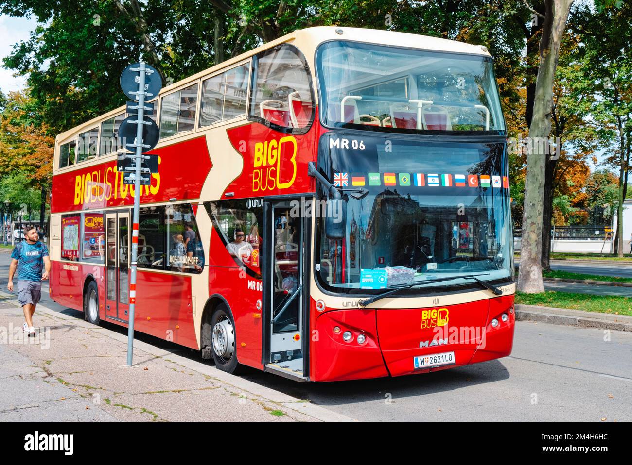 Vienna, Austria - August 28, 2022: A double-decker tour bus stopped on the street next to a landmark in Vienna, Austria Stock Photo