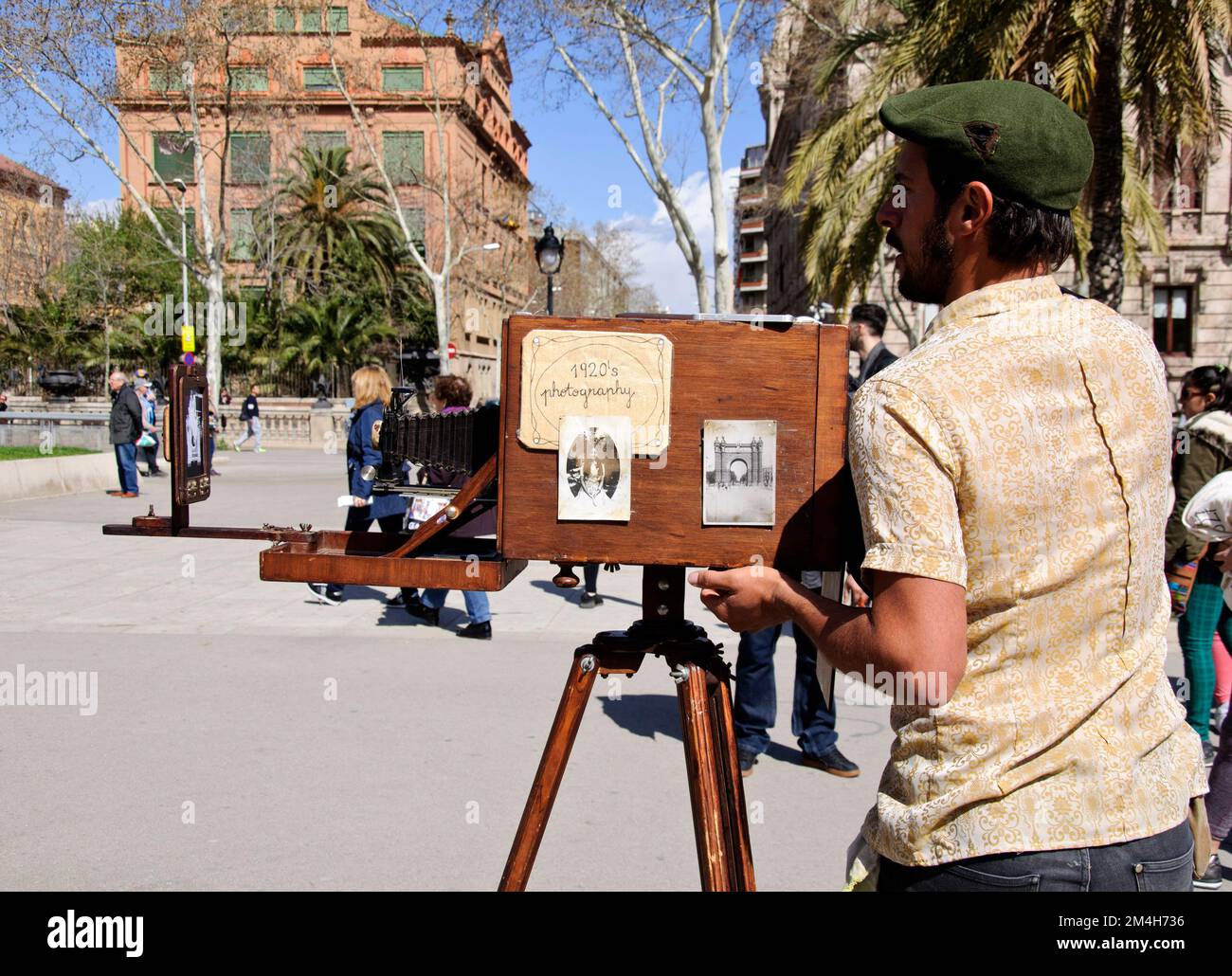 Minute photographer taking pictures with the vintage camera in Avenida Lluís Companys, Barcelona, Ciutat Vella, Spain Stock Photo
