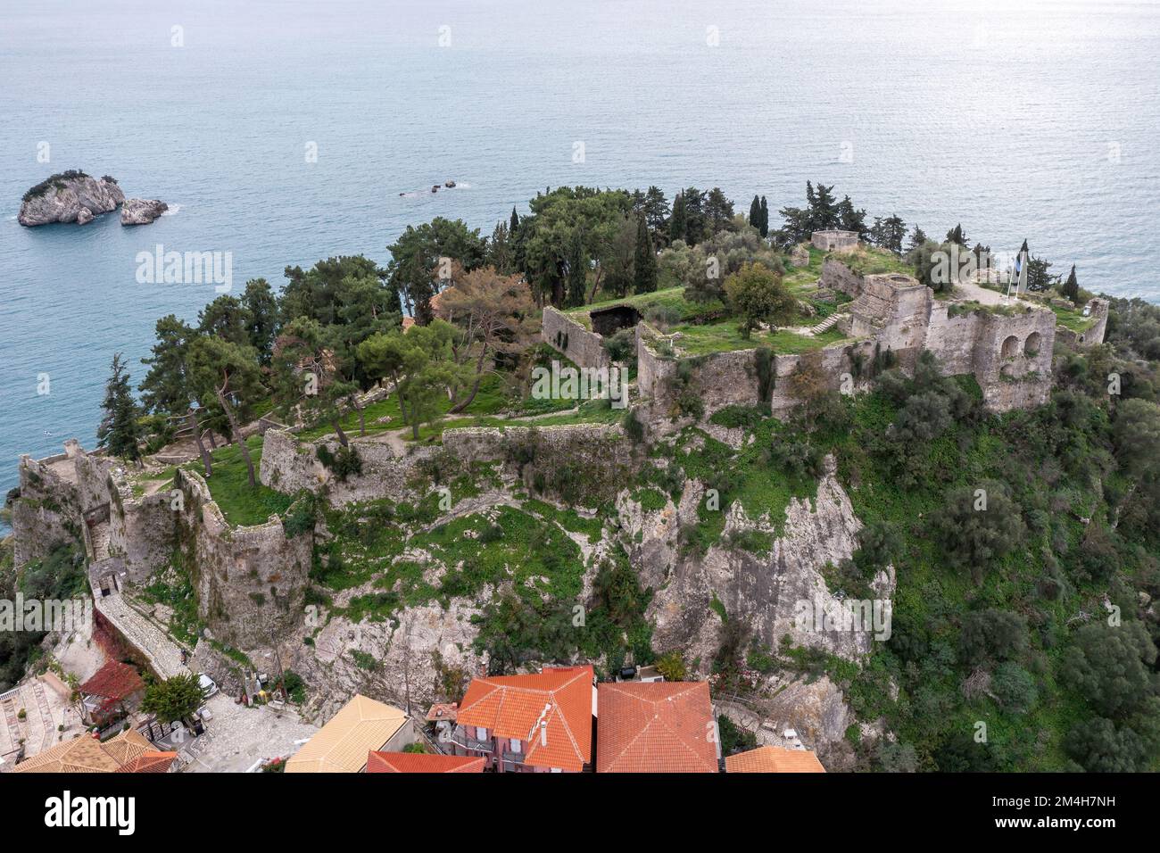 Parga city, Greece aerial drone view of Venetian Castle ruins, cloudy blue sky background. Stock Photo