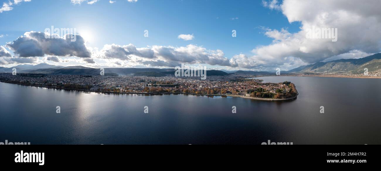 Greece, Ioannina  city. Aerial panoramic drone view of Giannena and Lake Pamvotis, cloudy blue sky. Epirus. Stock Photo