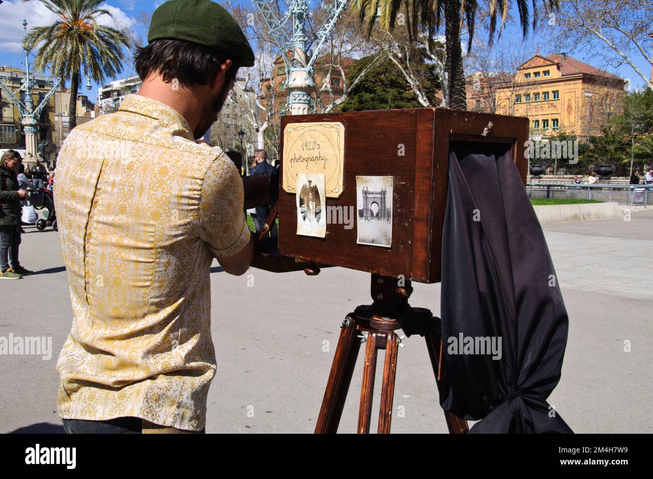 Minute photographer taking pictures with the vintage camera in Avenida Lluís Companys, Barcelona, Ciutat Vella, Spain Stock Photo