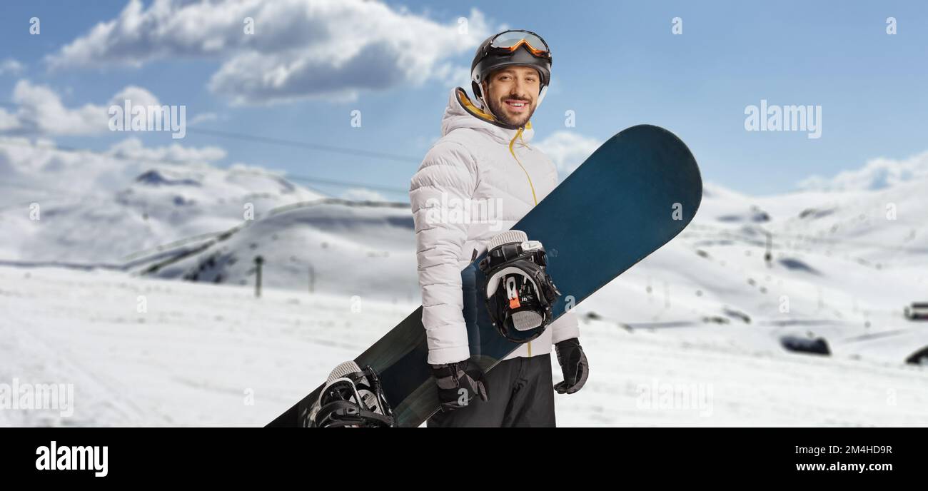Male snowboarder posing on a snowy mountain Stock Photo
