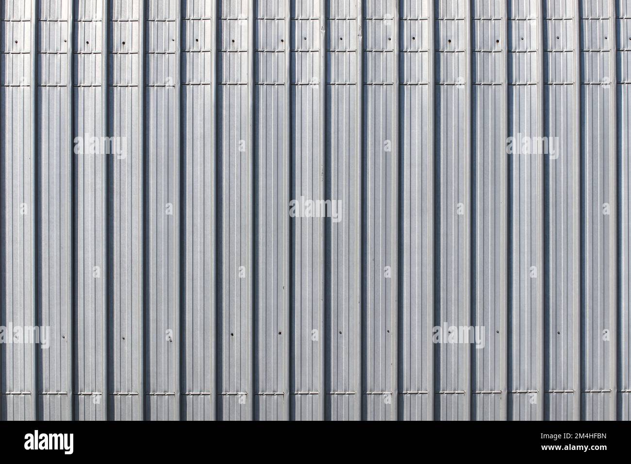 Silver abstract pattern is a vertical pattern from sheet metal. Stock Photo