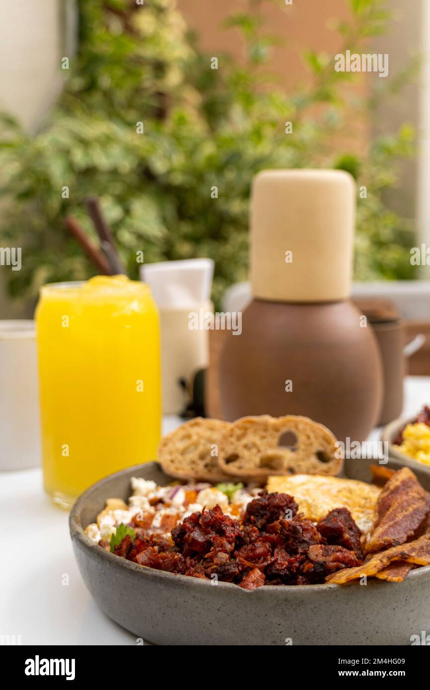traditional full breakfast in mexico, with sauces, juices, pans as hot