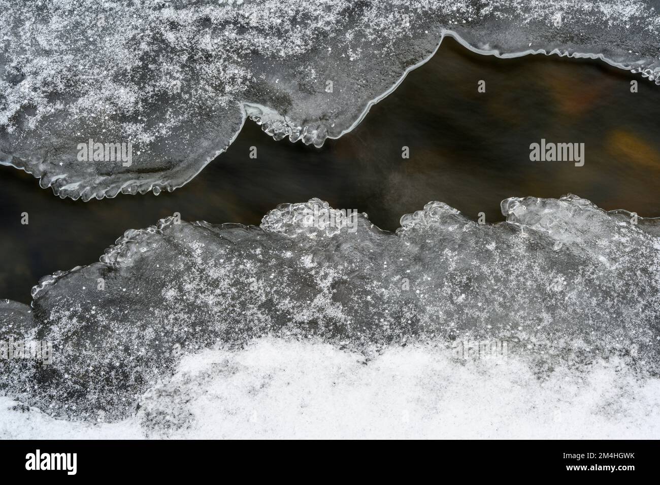 Ice formation with dusting of snow in a small creek, Greater Sudbury, Ontario, Canada Stock Photo
