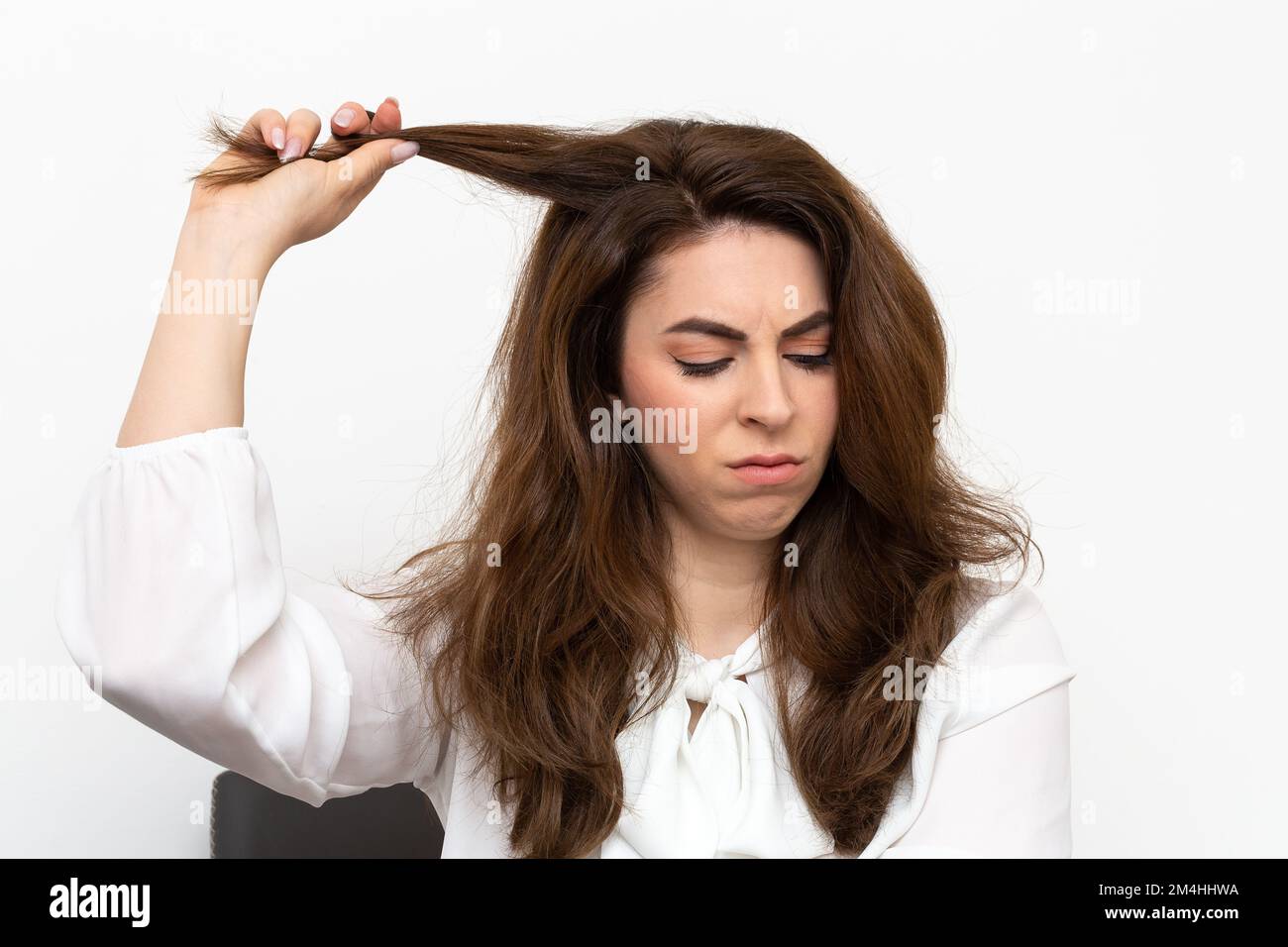 Young woman suffering from trichotillomania, a compulsive psychological disorder in which the