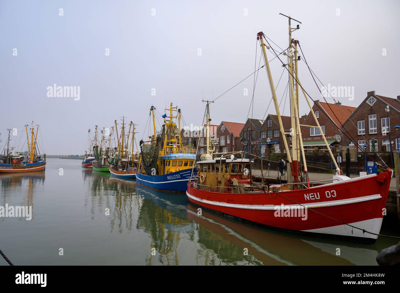 NEUHARLINGERSIEL, GERMANY - NOVEMBER 26, 2022: Harbor with shrimp cutters Stock Photo