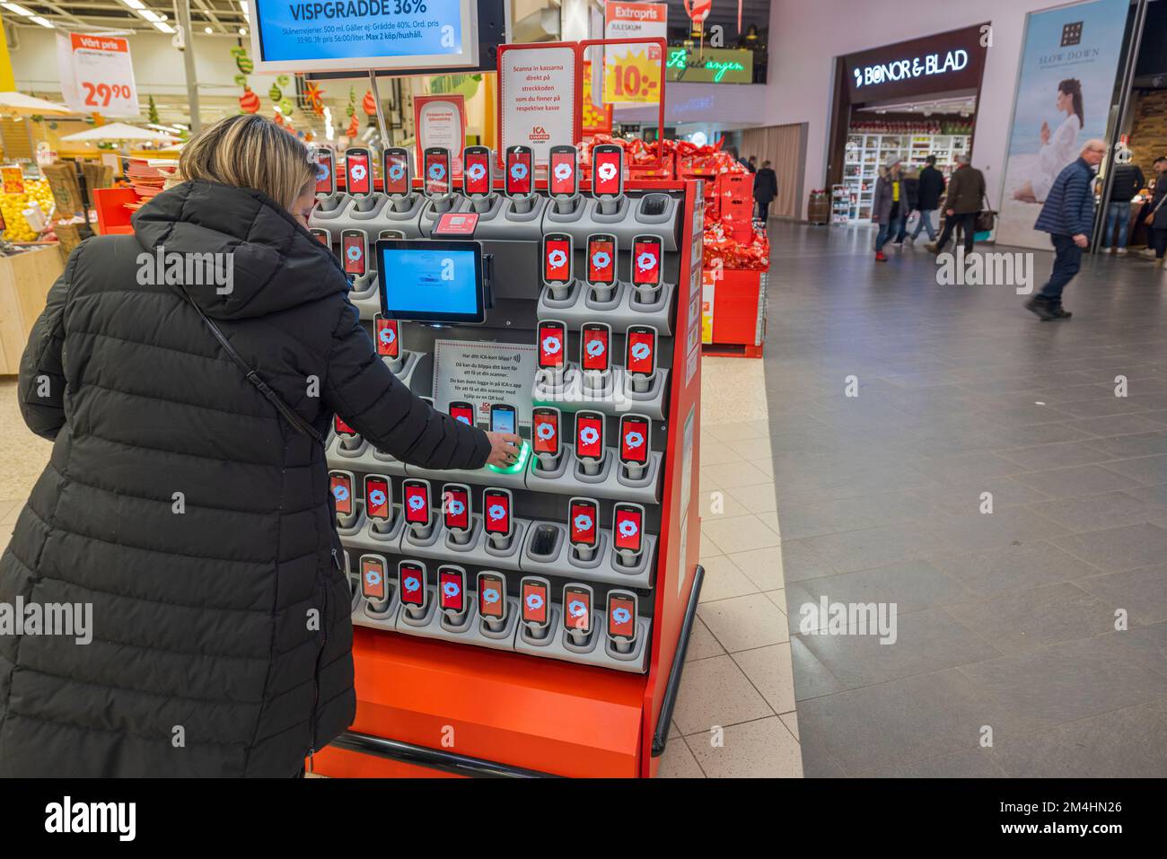Technological view of interior of ICA supermarket. Female client in