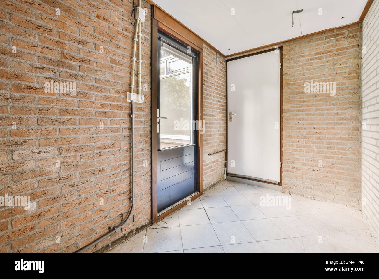 the inside of a house with brick walls and doors that have been painted ...