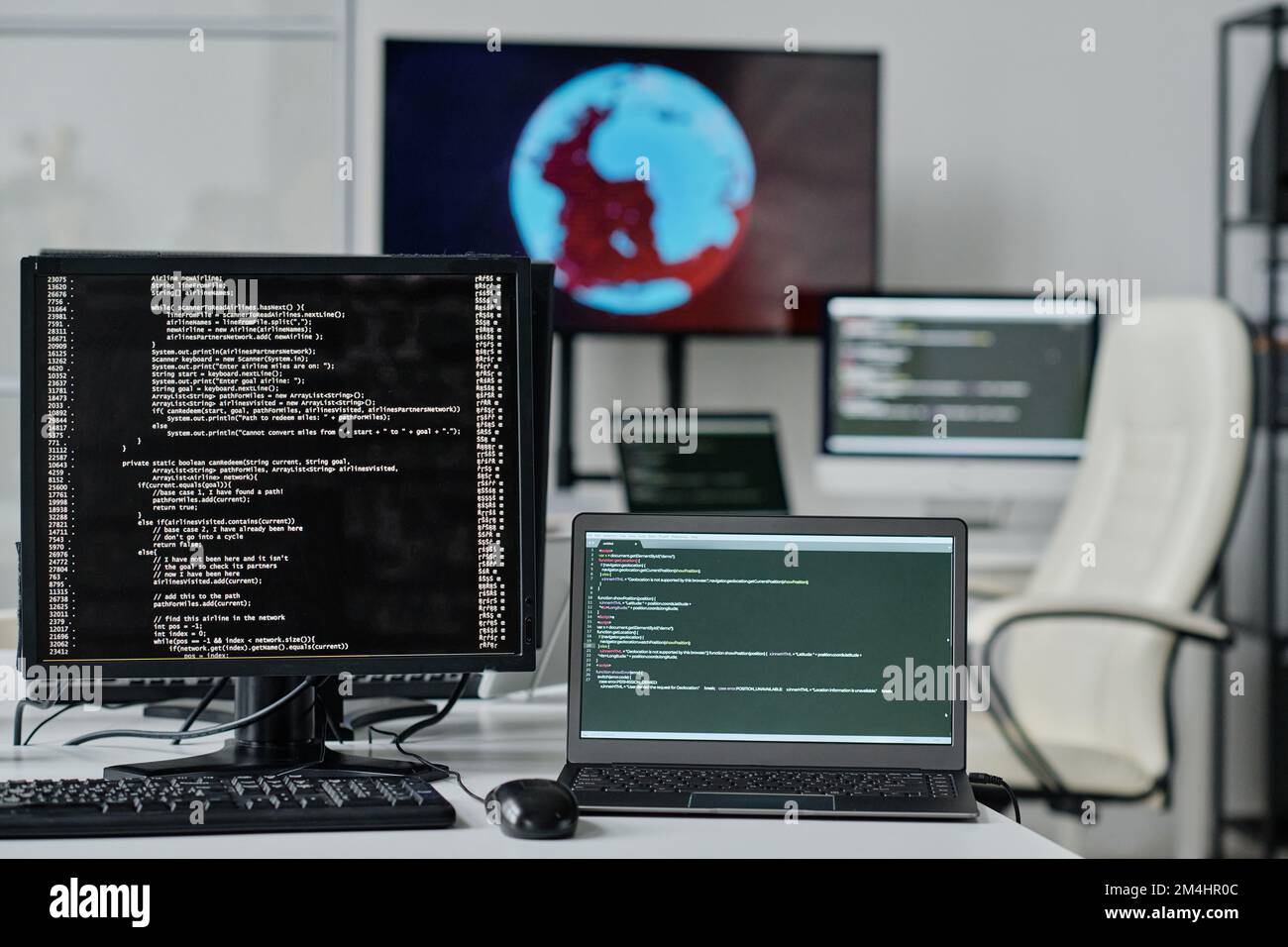 Close-up of computer monitor with codes on the screen standing on table ...