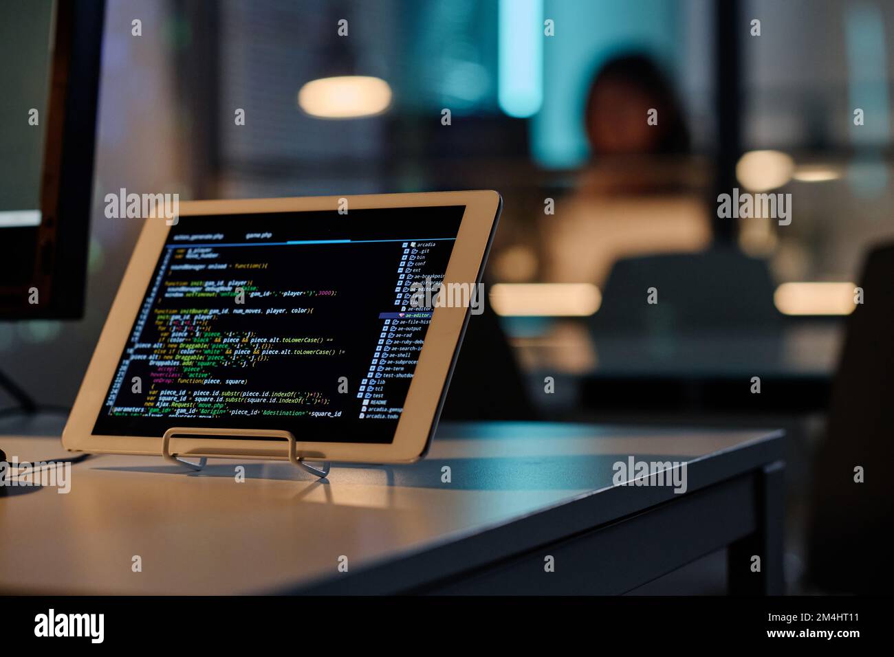 Close-up of digital tablet with security program codes on touch screen standing on table of developer Stock Photo