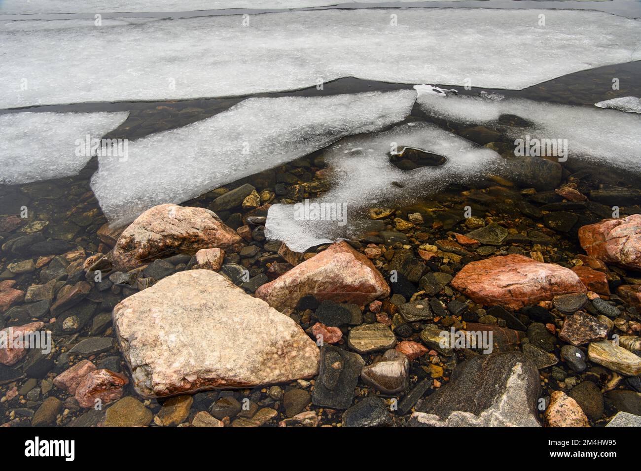 Melting ice, shoreline granite rock on Georgian Bay in early spring, Parry Sound, Ontario, Canada Stock Photo