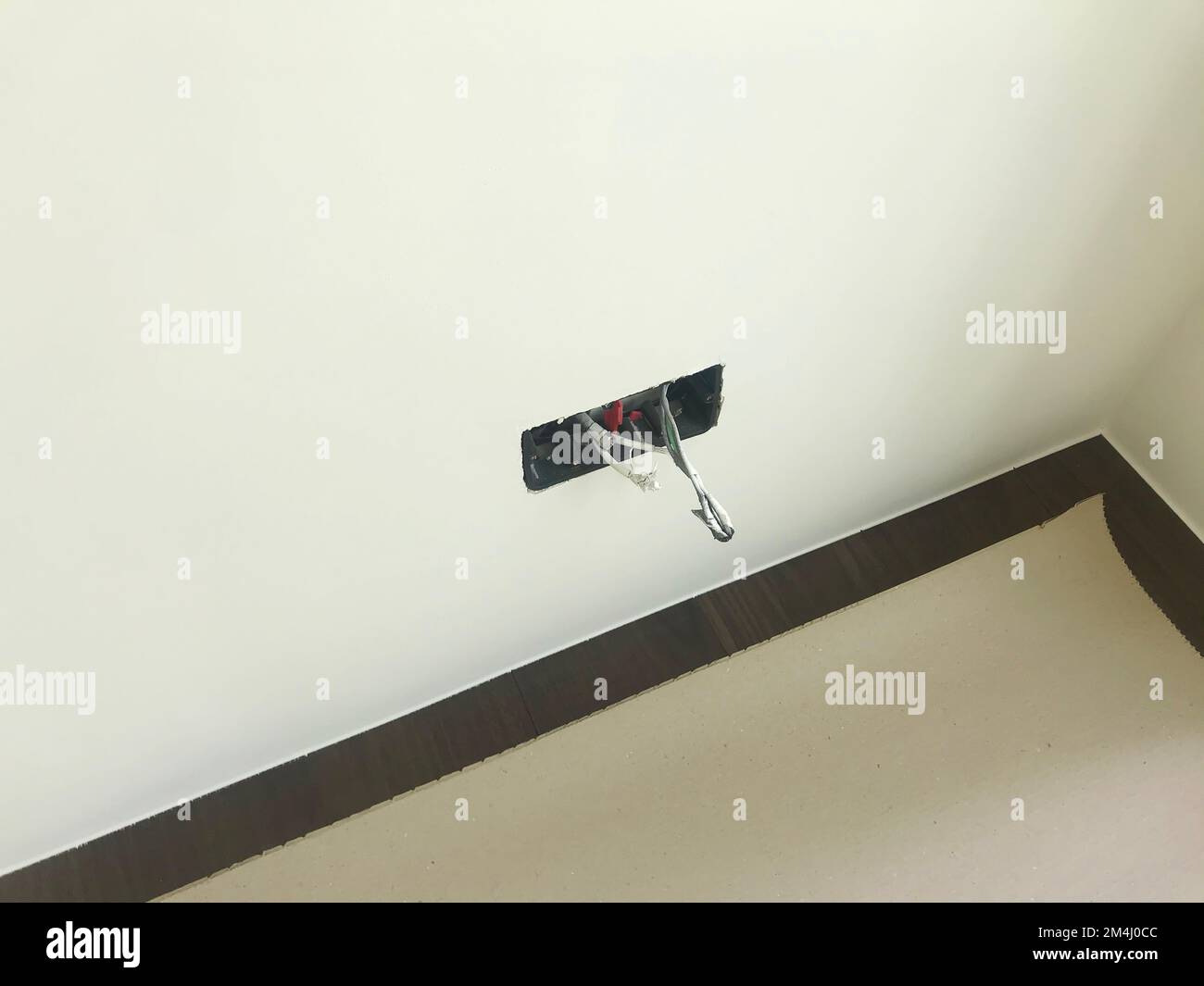 An electric work of wall outlet with cables and sockets on the white