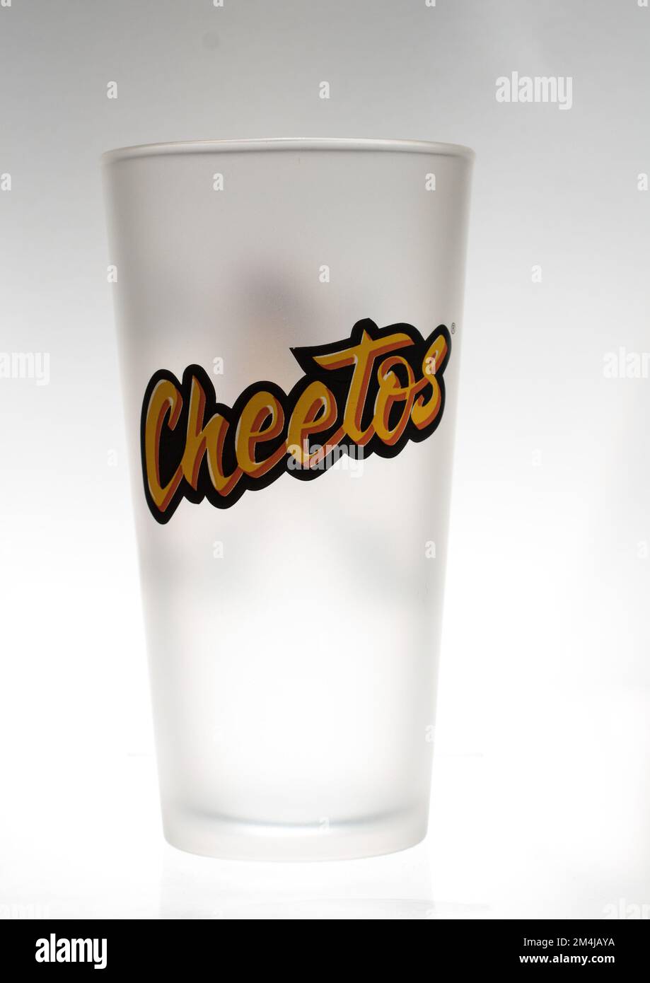 Wash down your favorite, cheesy foods with the right drink ware. Cheetos Chester Cheetah frosted glassware! Stock Photo