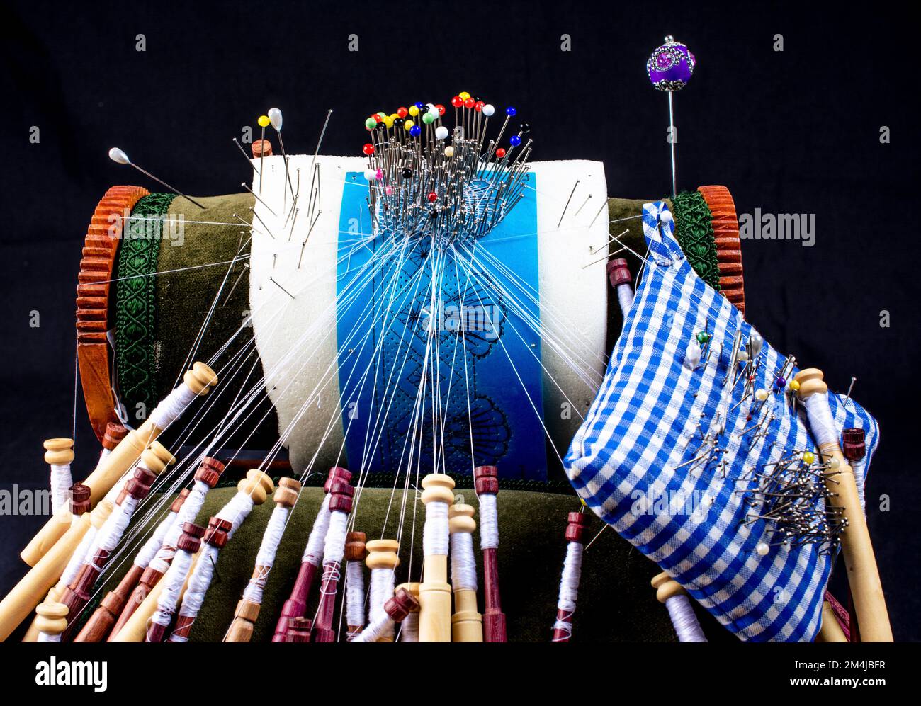 Roller pillow to make bobbin lace. Bobbin lace is a lace textile made