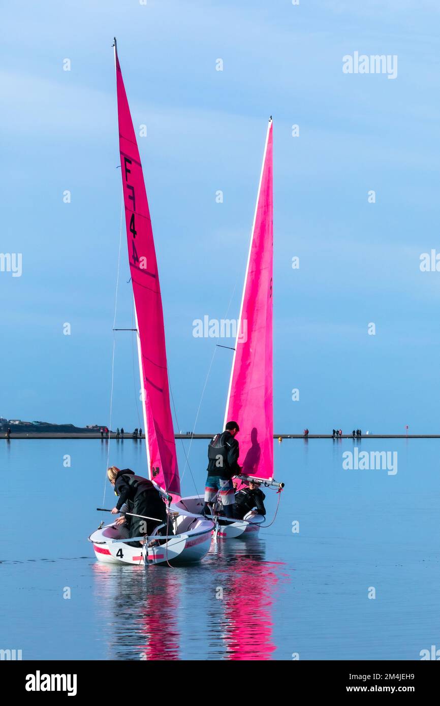 Colourful sailing dinghies from West Kirby Sailing Club reflected in