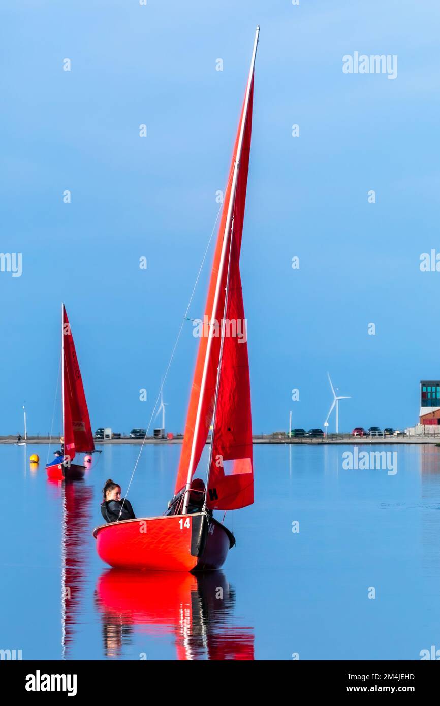 Colourful sailing dinghies from West Kirby Sailing Club reflected in