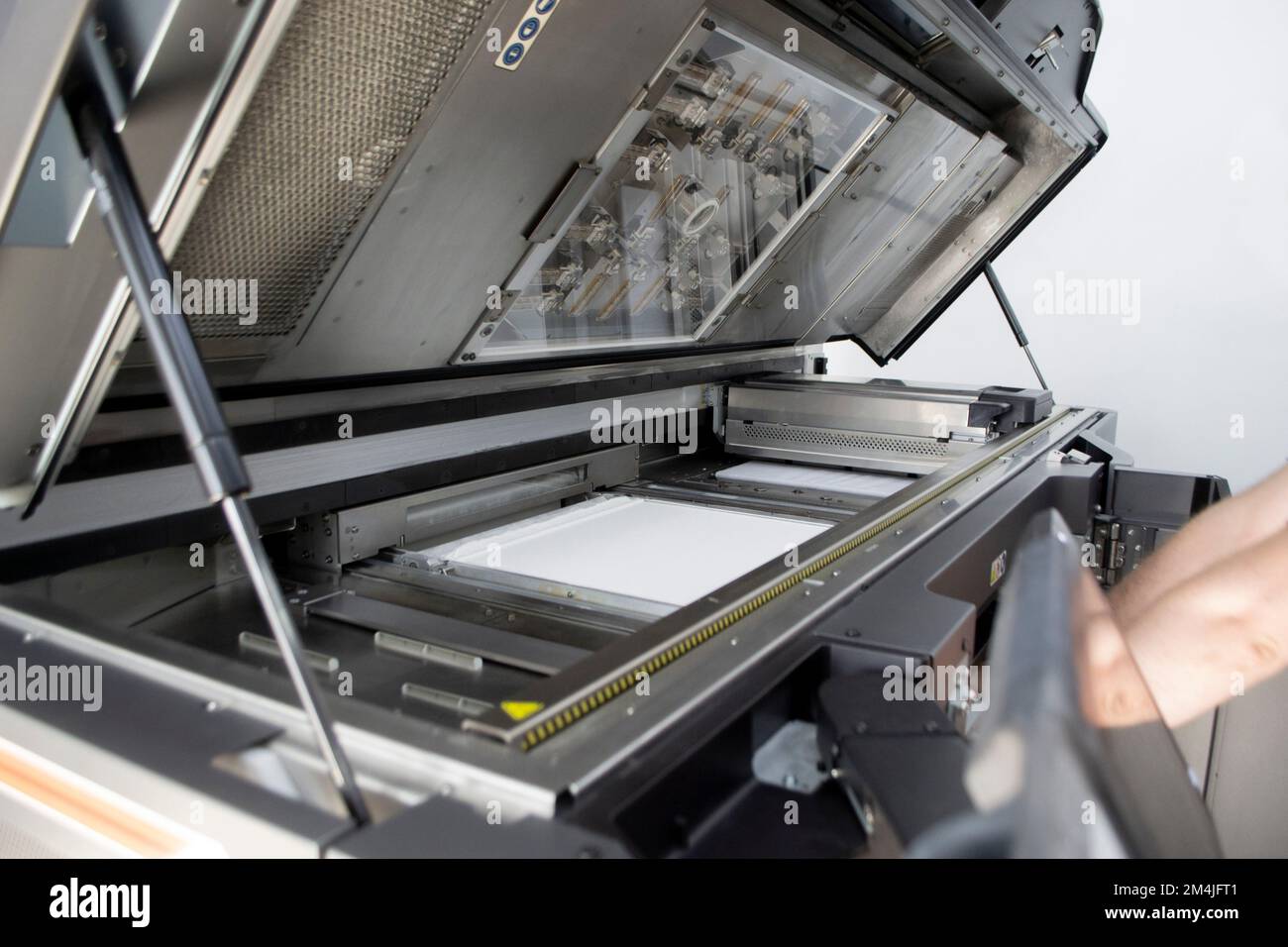 White polyamide powder on working surface of open 3D printer. White