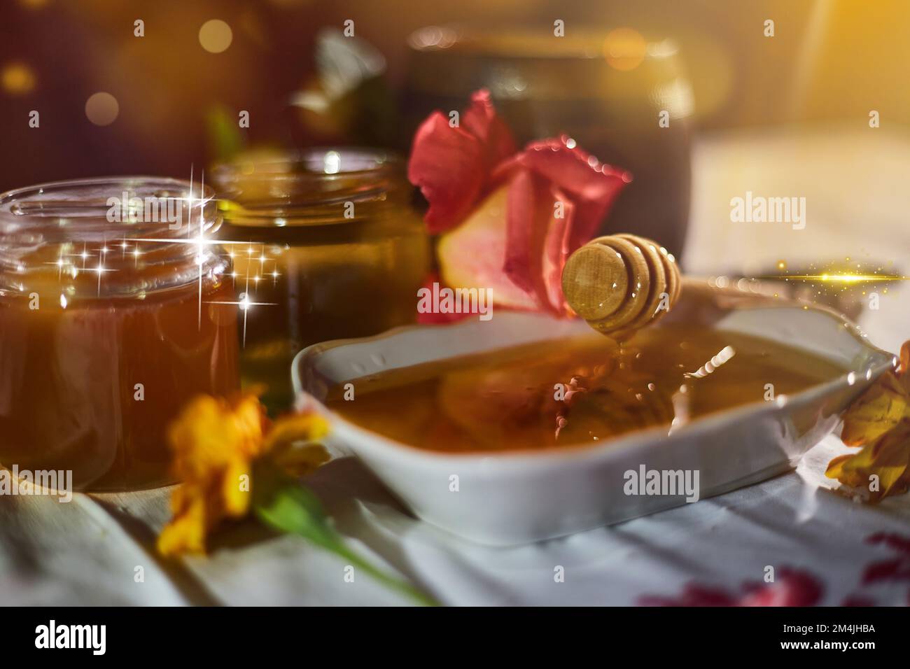 a jar of sweet honey on a table from the garden with apples in a glass  Stock Photo