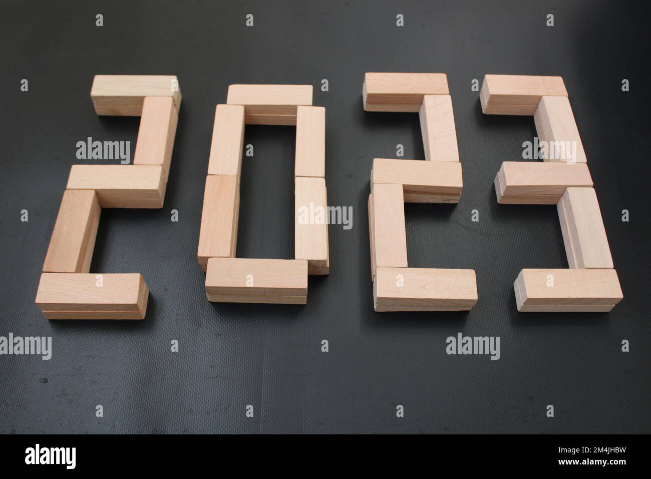 The number 2023 written in wooden blocks. Beginning and start of the new year 2023. Preparation for happy new year ,new life, new business, plan. Stock Photo