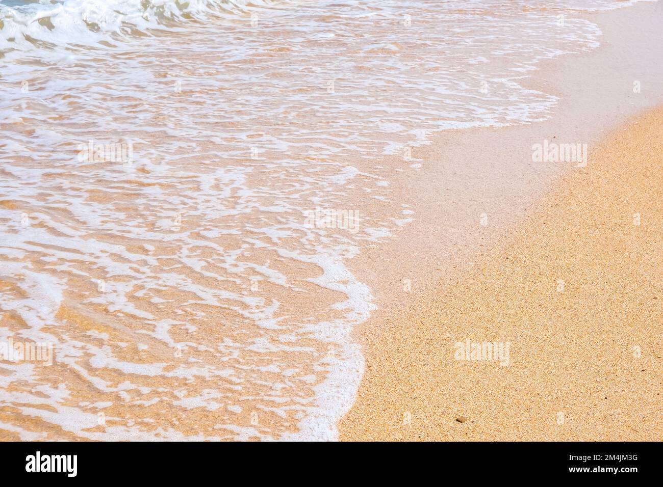 Transparent waves roll on sandy hi-res stock photography and images - Alamy