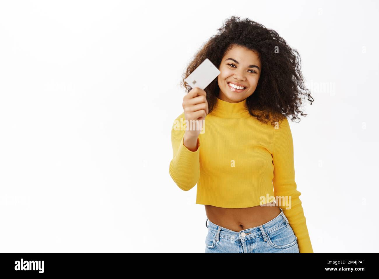 Smiling Black girl shows her credit card, student id, makes thumbs up ...