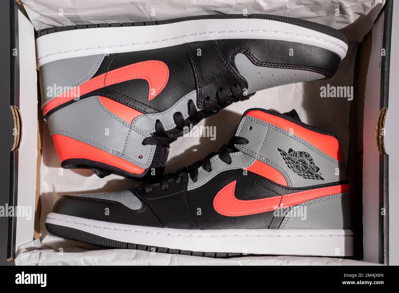 Prague, - 16 May 2021: Unboxing a package from Nike arrived Jordan model 1 Mid custom HOT PUNCH Pink Shadow. custom sneaker top view. Stock Photo - Alamy
