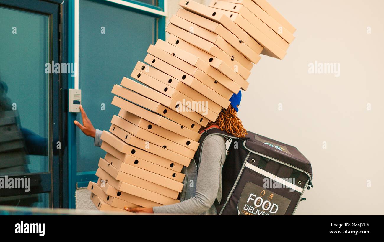 Reckless delivery worker dropping pizza boxes, scared courier running