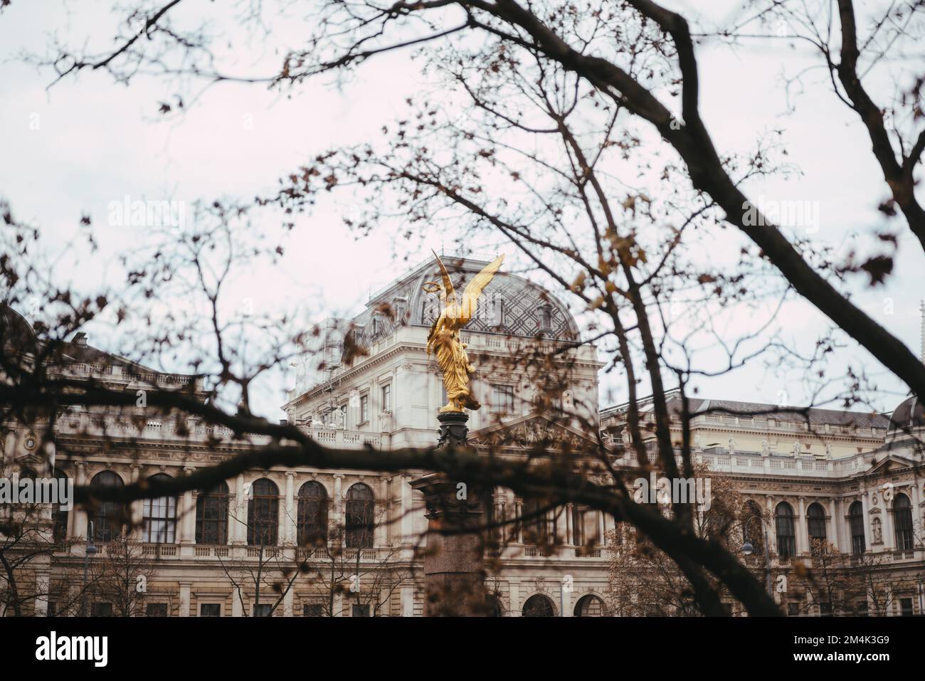 Wien, 17.12.2022: Golden Angel with laurel wreath on Liebenberg monument located in front of Vienna University Stock Photo
