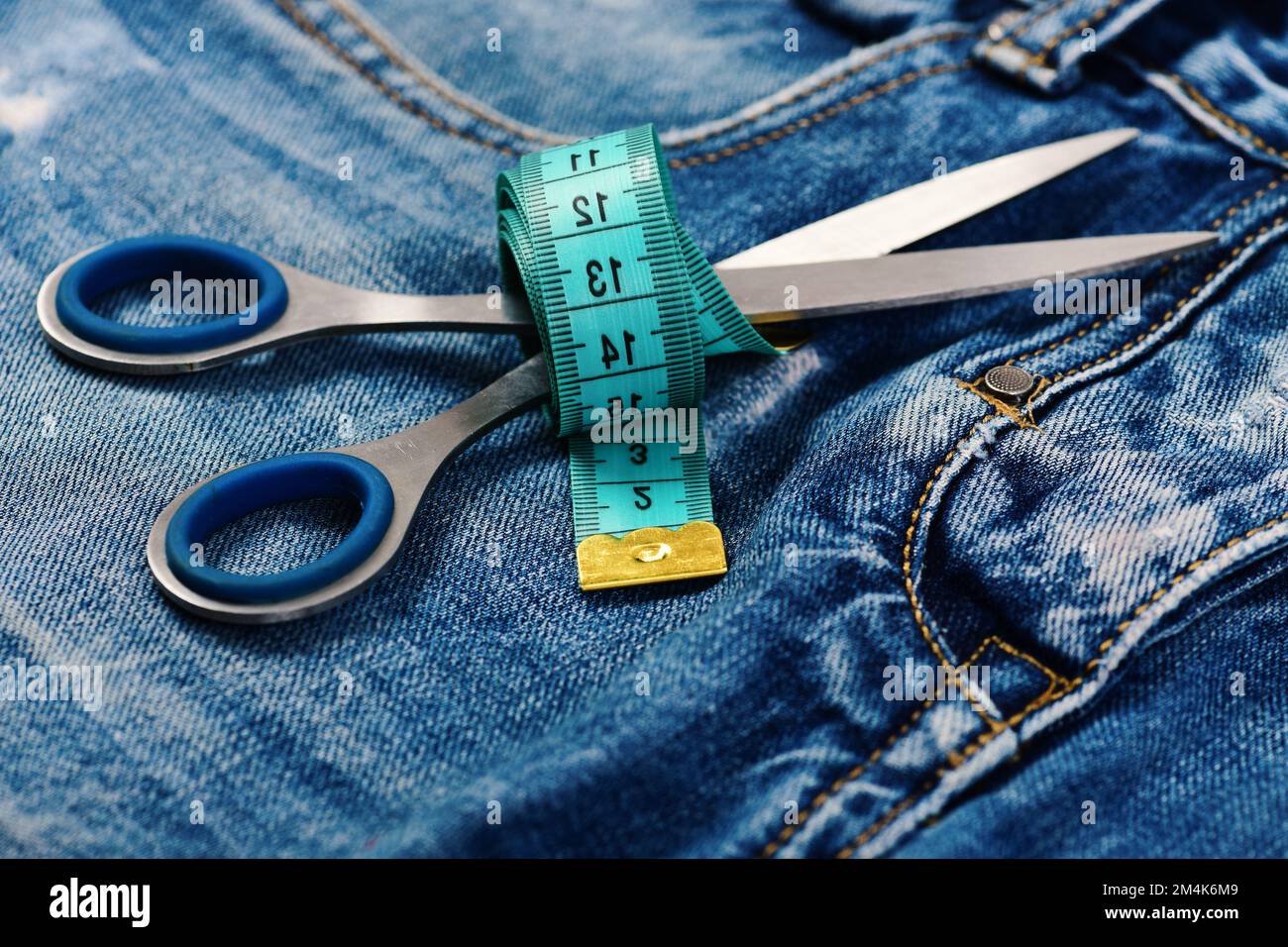 https://c8.alamy.com/comp/2M4K6M9/jeans-crotch-and-pocket-with-scissors-and-measure-tape-2M4K6M9.jpg