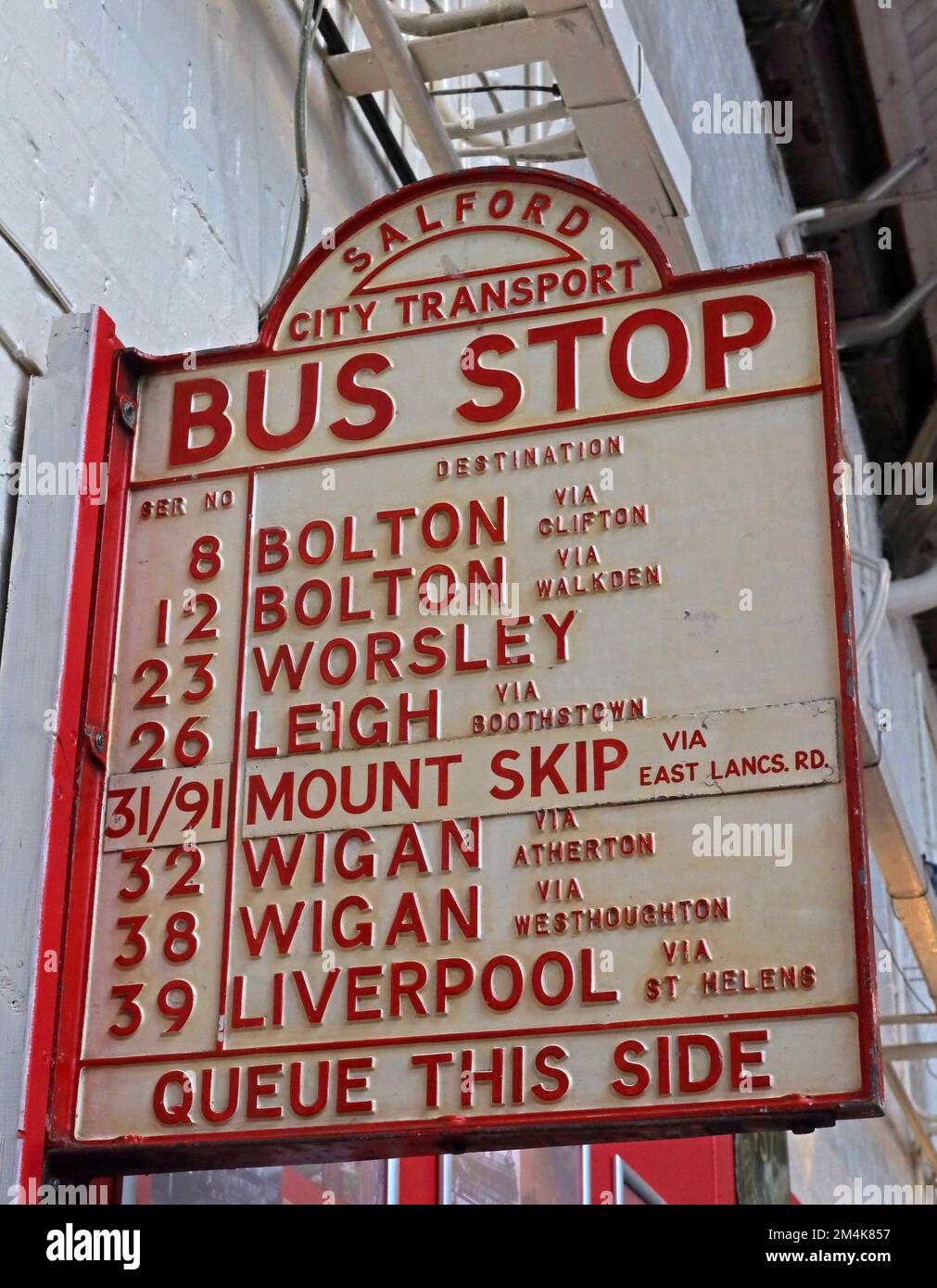 Salford City Transport, bus stop, destinations, Queue this side, Bolton, Worsley, Leigh, Mount Skip, Wigan , Liverpool Stock Photo