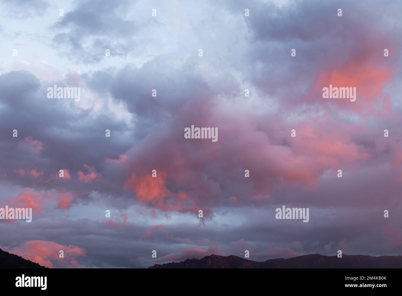 Storm clouds with amazing colours reverse sunset. Stock Photo