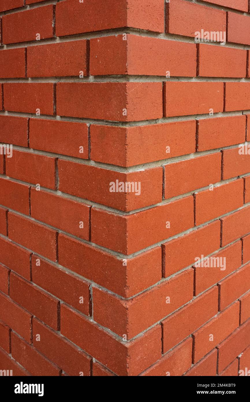 Red brick texture of the corner of the house. New Brick wall for