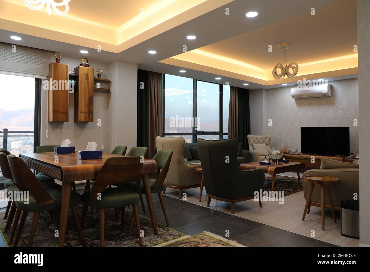A modern interior design of a living room with wooden tables and chairs ...