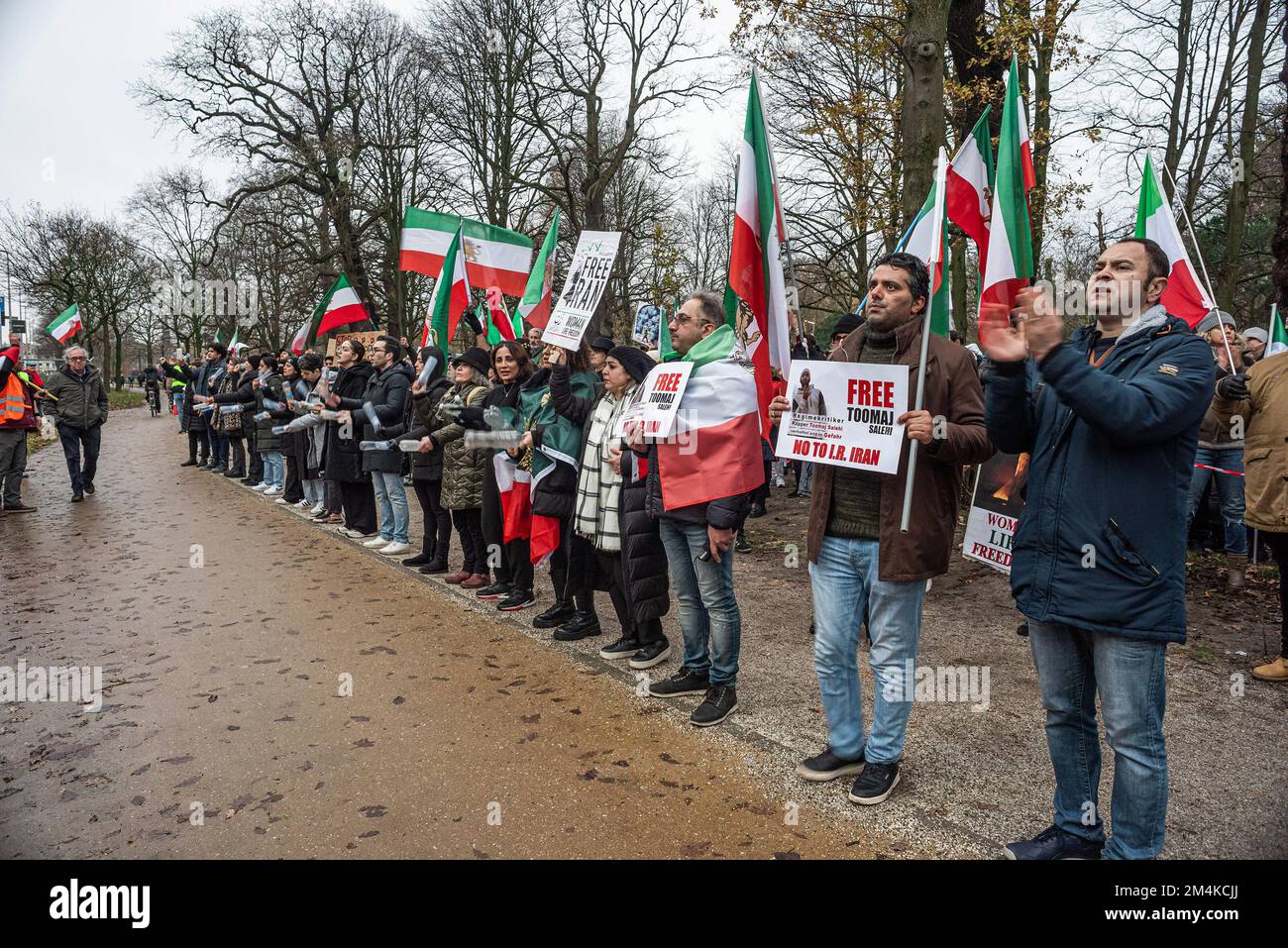 The Hague, Netherlands, 21/12/2022, A group of male and female protesters, during today's demonstration in The Hague, denouncing the Iranian regime; with flags and placards. A not too large, but very vocal group of Iranian supporters, staged a noisy protest this afternoon, they called for the Dutch House of Representatives to close the Iranian Embassy in the Netherlands and to expel its diplomates. Mass demonstrations erupted in Iran some weeks ago, after Security forces cracked down on protesters. Of the arrests made, two accounted for the sudden deaths of 22-year-old Mahsa Amin and 17-year-o Stock Photo