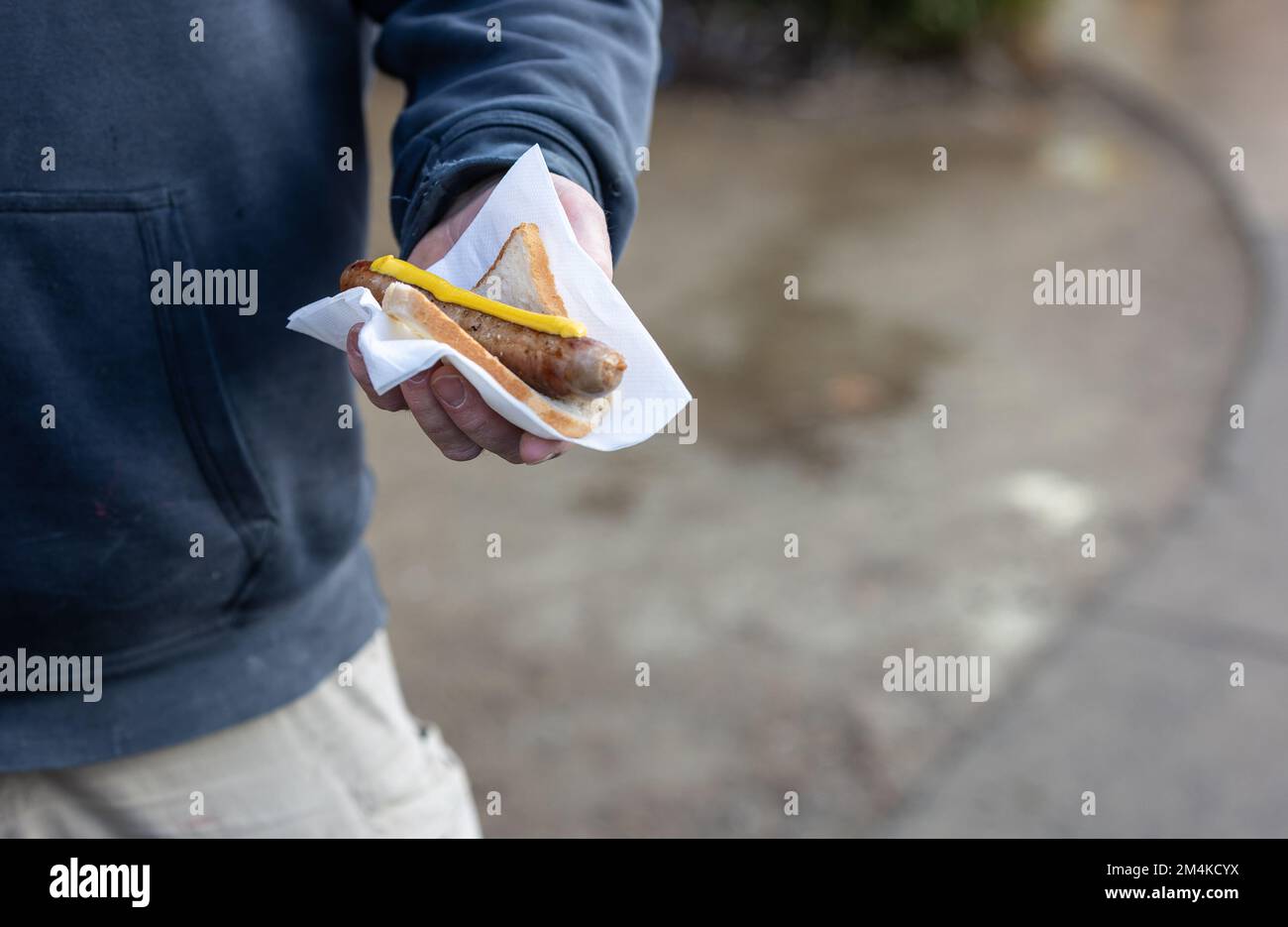 Man with sausage in bread Stock Photo