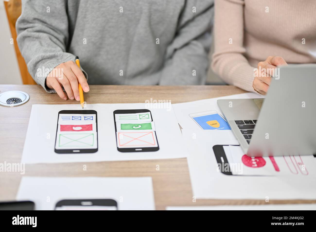 close-up image, Team of professional mobile application developers checking and testing their new prototype in the meeting. Stock Photo