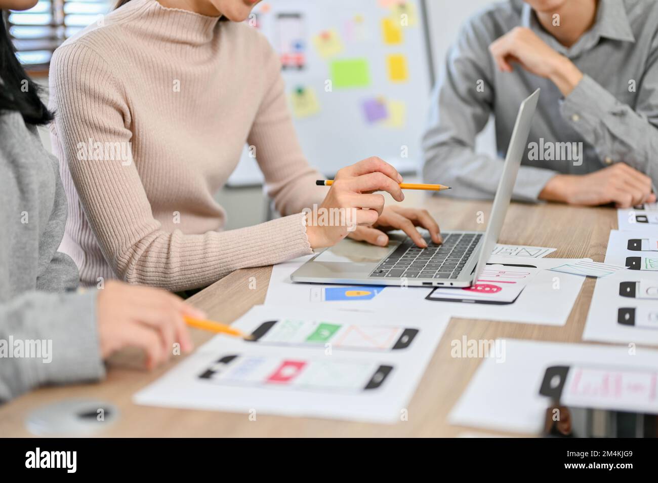 A team of professional millennial Asian website and mobile app developers are in the meeting. user experience and interface design. cropped image Stock Photo