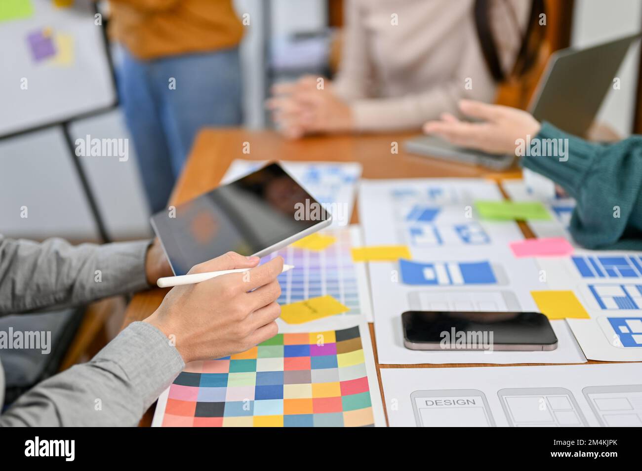 close-up image, A team of professional website and mobile application designers are in the meeting, brainstorming user interface design. UX UI Stock Photo